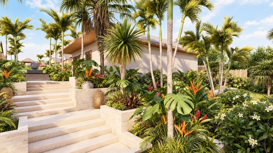 Entrée de la résidence, allée bordée de palmiers et de jardins tropicaux